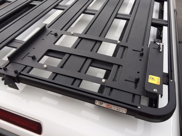 Heavy-duty black roof rack platform mounted on vehicle for overlanding accessories
