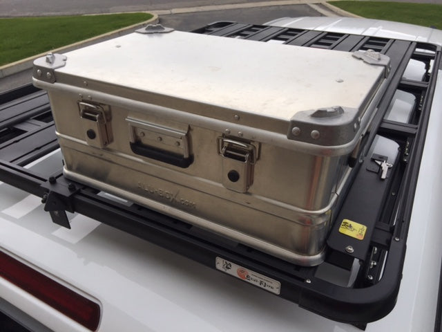 Aluminum expedition storage case mounted on a roof rack for overlanding vehicle accessories