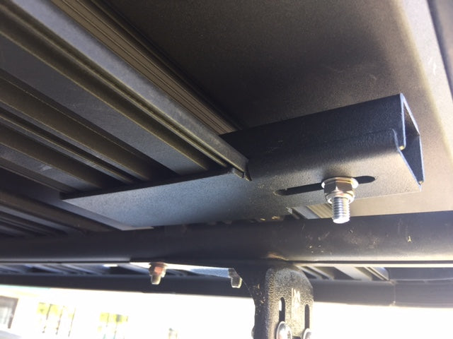 Close-up of roof rack mounting bracket with bolt for overlanding vehicle accessories