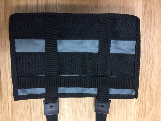 Black tactical MOLLE storage panel with gray stripes, designed for vehicle overlanding gear