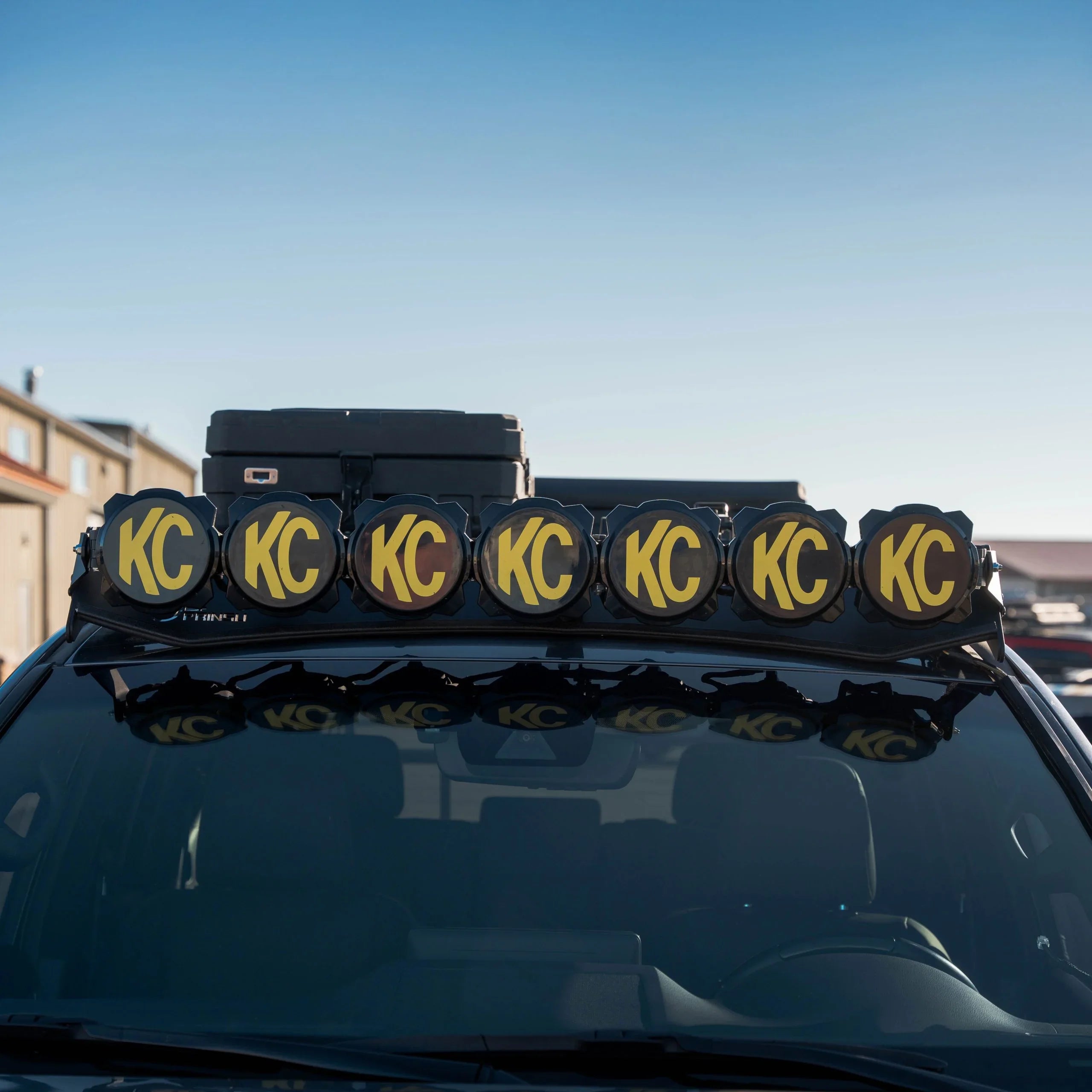 Off-road vehicle roof with mounted KC lights for overlanding and expedition gear