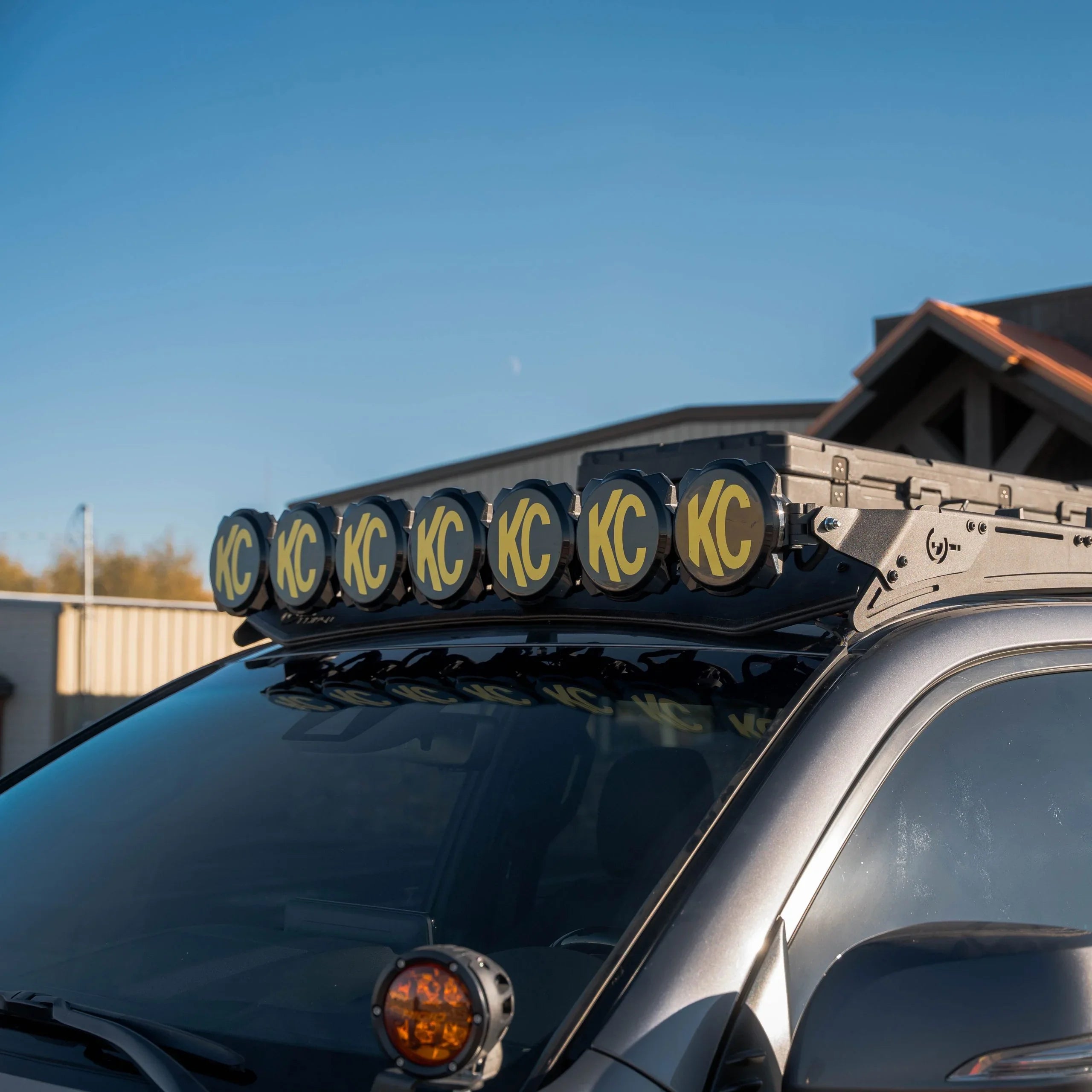 Off-road vehicle with KC roof lights and roof rack for overlanding and expedition camping