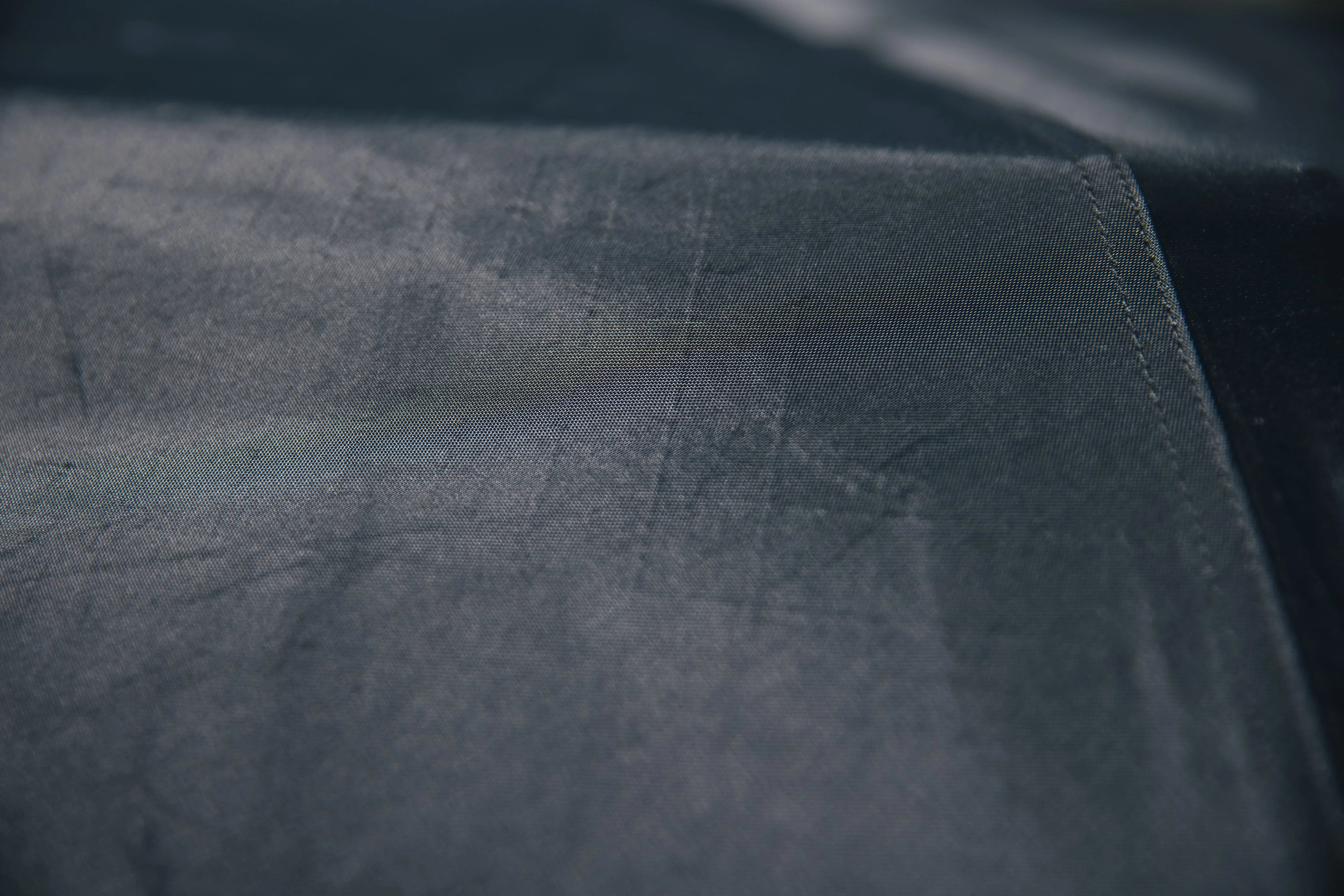 Close-up of durable black ripstop fabric, ideal for camping and overlanding gear