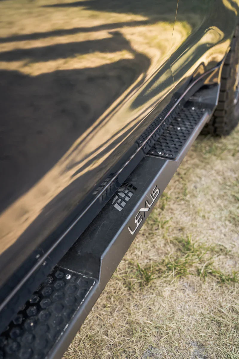 Lexus LX570 rock slider off-road side step on vehicle, black metal, outdoor setting