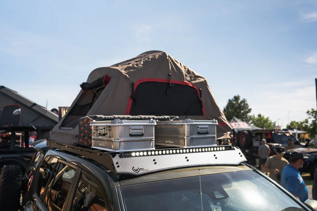 Lexus GX460 with Prinsu roof rack, rooftop tent, and camping gear in outdoor setting