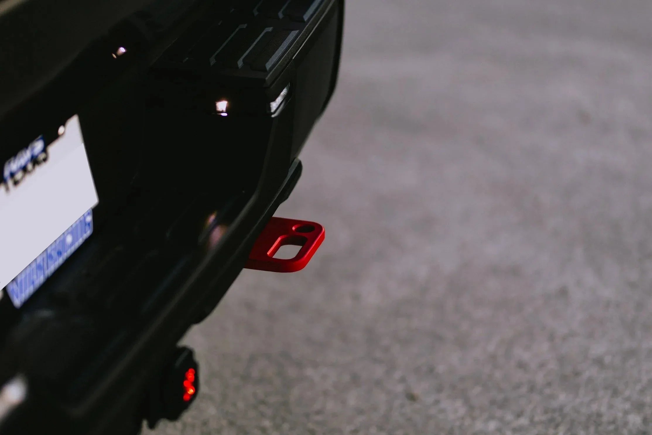 Close-up of a vehicle rear tow hook in red, suitable for overlanding and off-road accessories