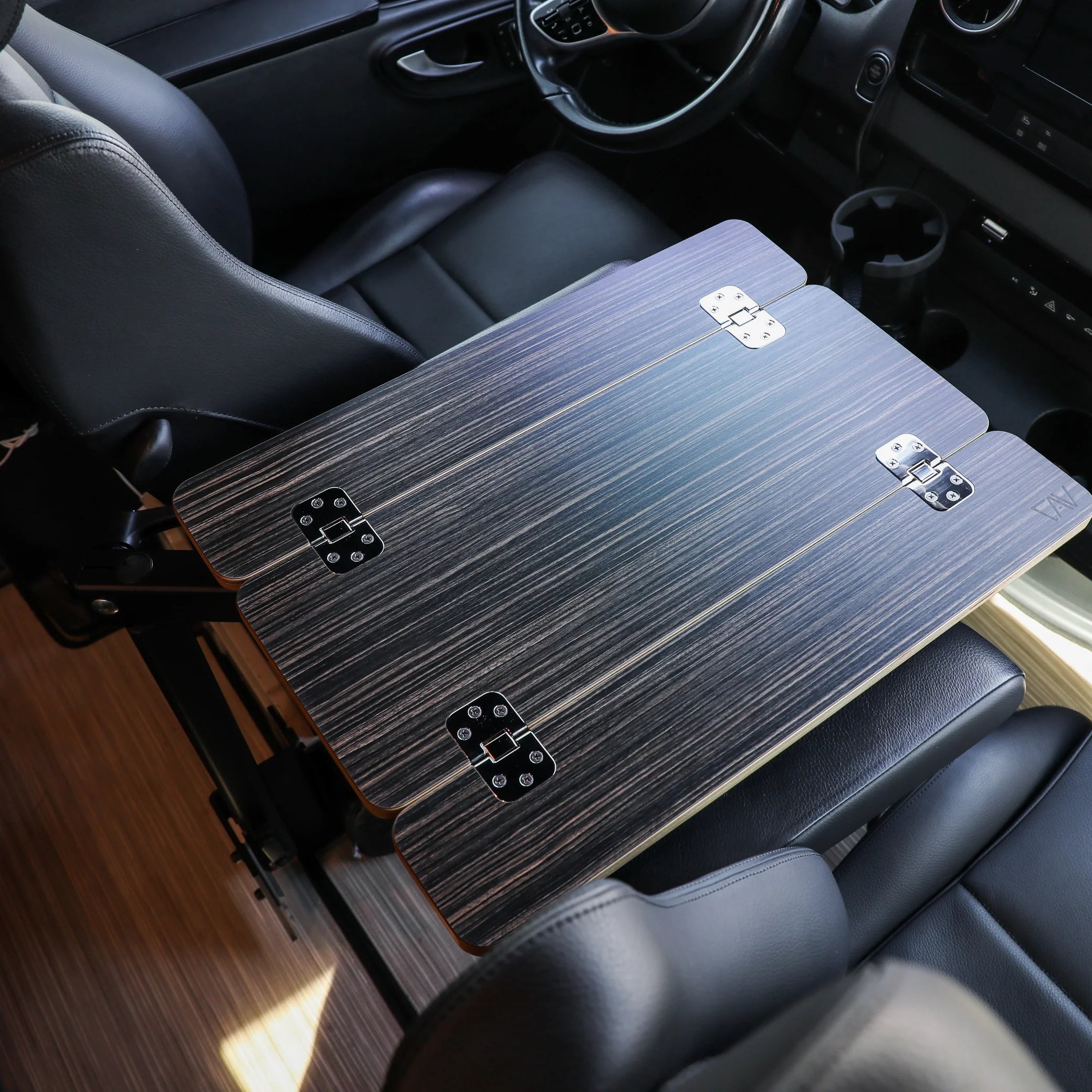 Folding vehicle interior table installed between car seats for overlanding or camping gear