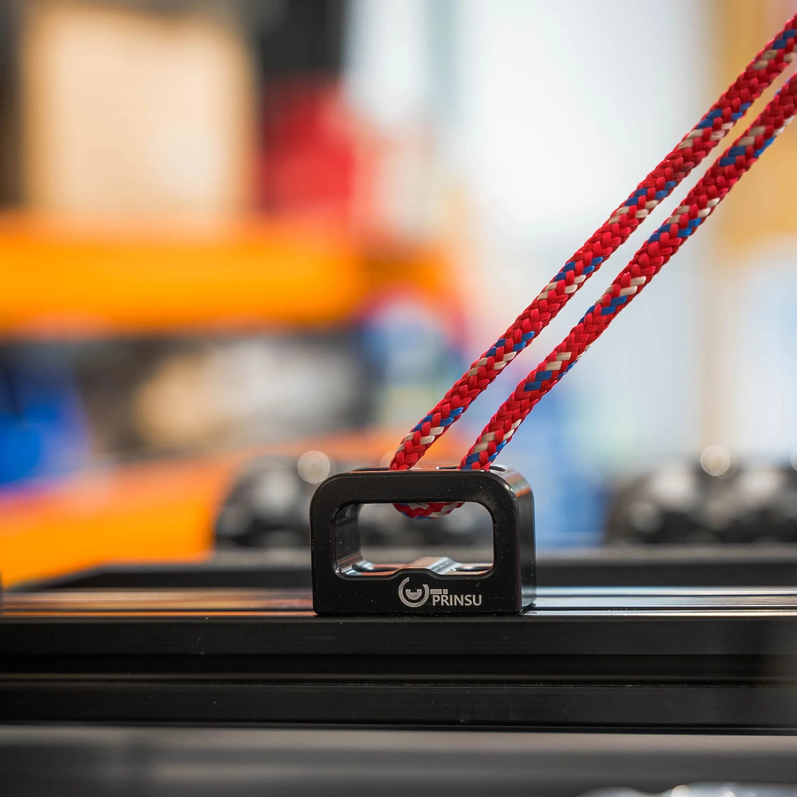 Prinsu multi-use anchor bracket with red utility rope attached, mounted on vehicle rack