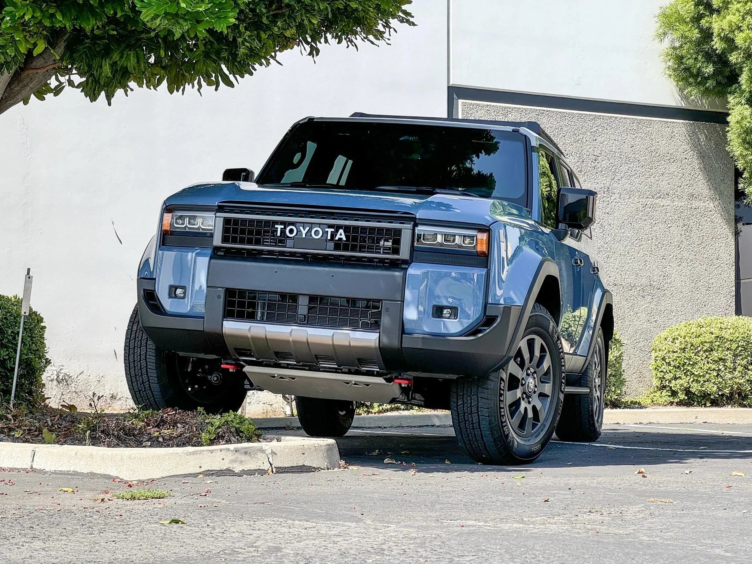 Blue Toyota 4Runner SUV parked outdoors, off-road on curb, showcasing rugged exterior.