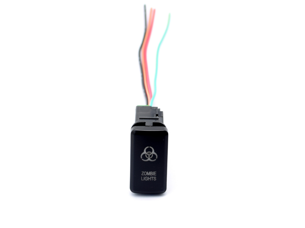 Black rocker switch with 'Zombie Lights' text, colored wires, for overlanding vehicles
