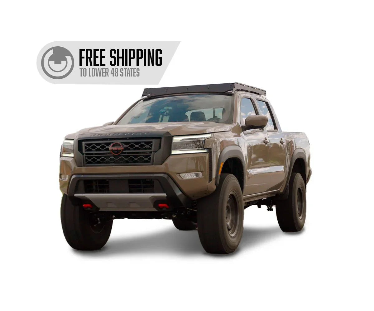 Beige Nissan pickup truck with off-road accessories and free shipping badge