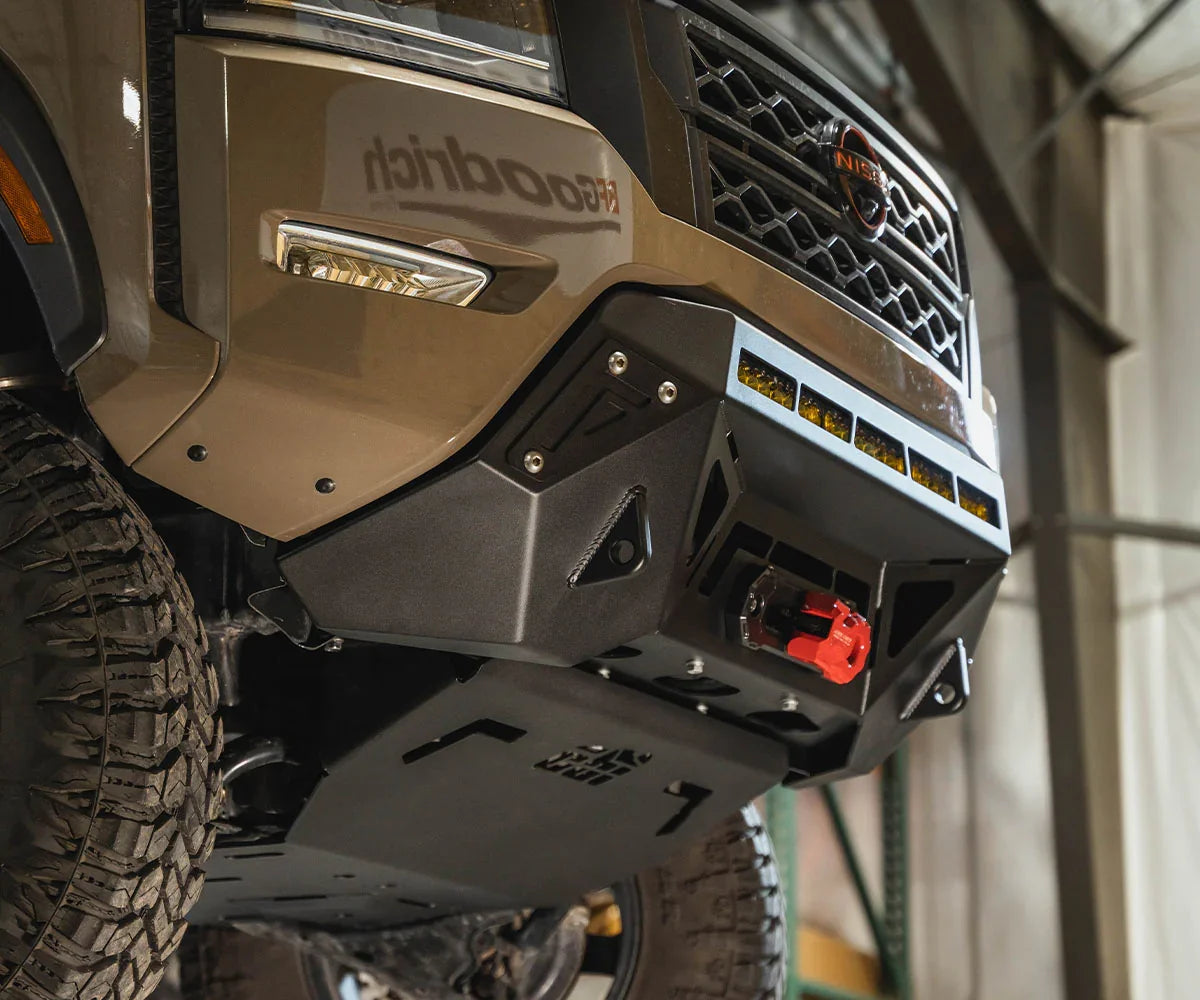 Close-up of Nissan Frontier front bumper with off-road winch and LED lights mounted