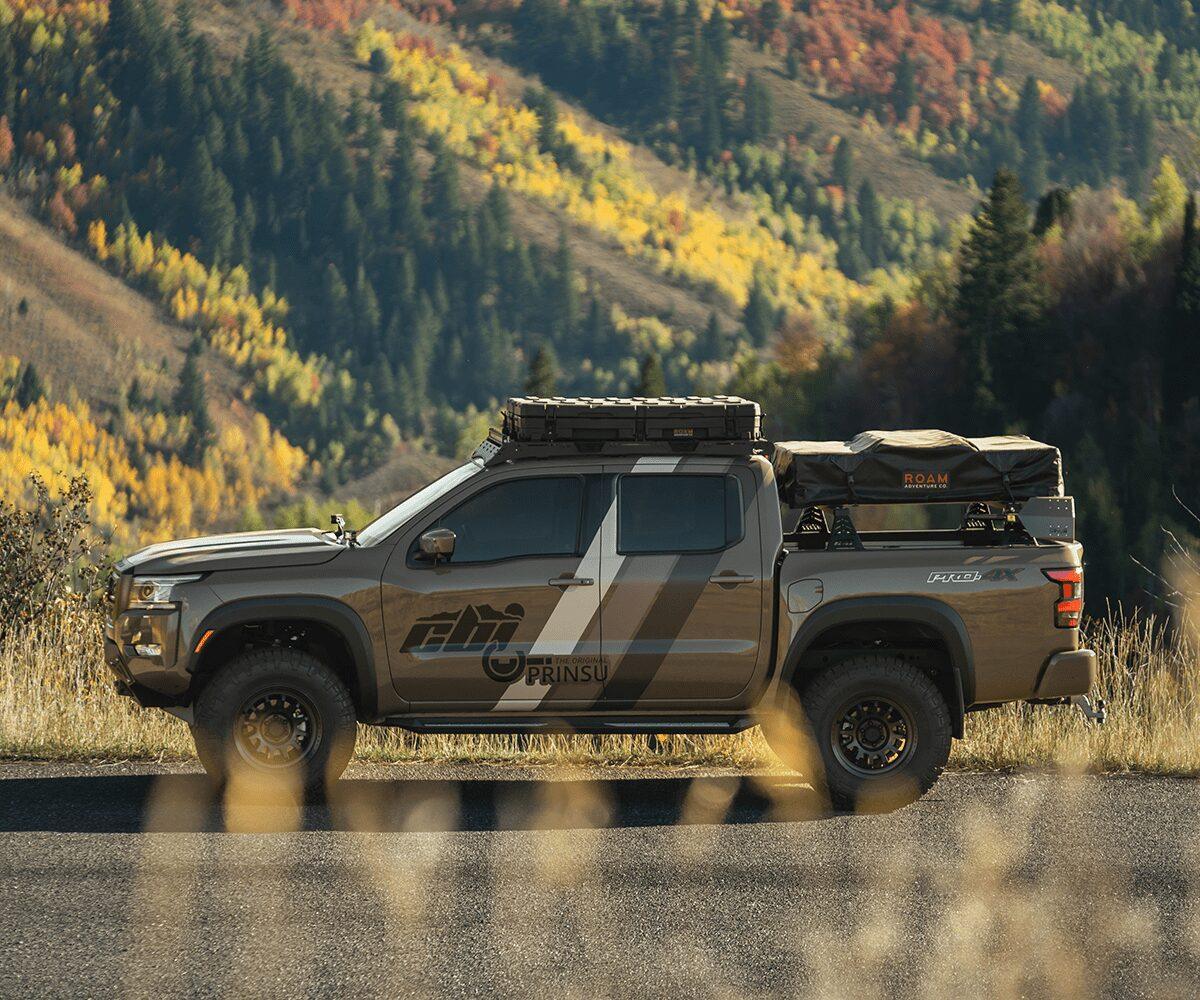 Nissan Frontier with Prinsu roof rack and adventure gear in fall mountain landscape