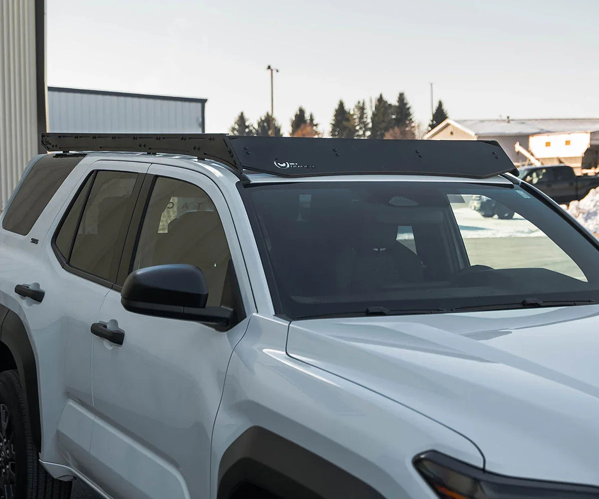 Black roof rack installed on white Toyota 4Runner, ideal for overlanding accessories