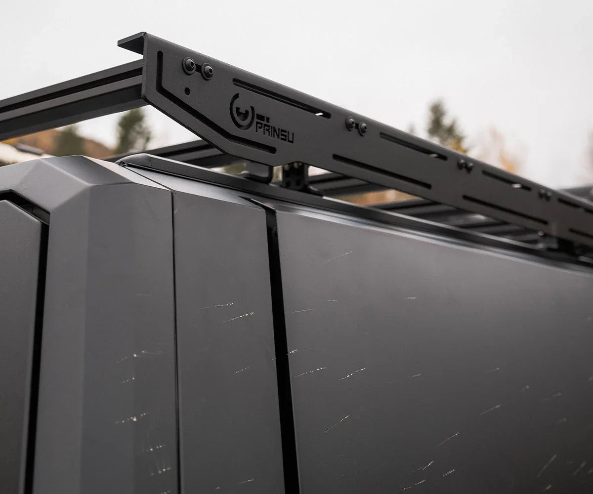 Black Prinsu roof rack mounted on a gray overlanding vehicle roof, outdoor setting