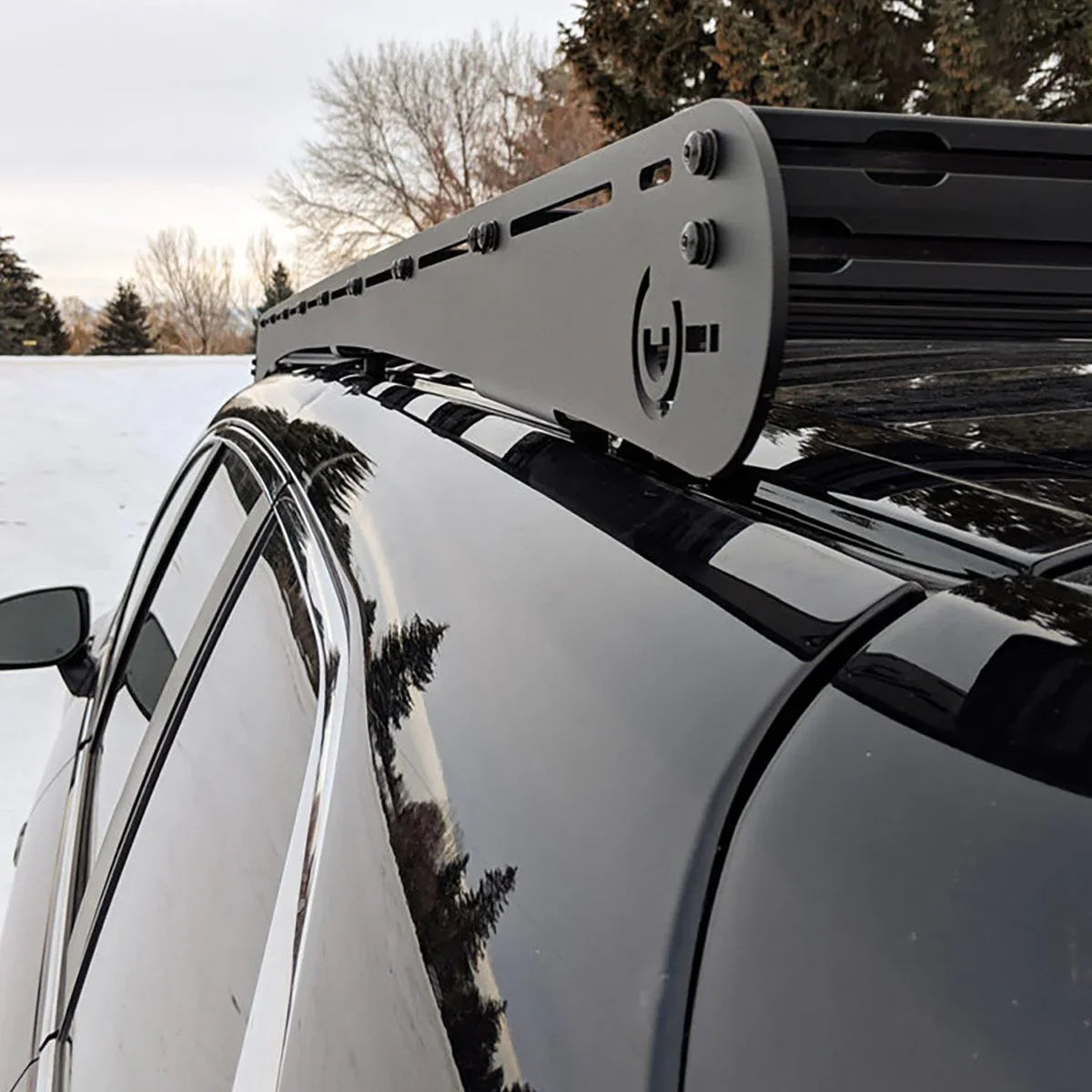 Aluminum roof rack mounted on a black SUV for overlanding and camping gear transport