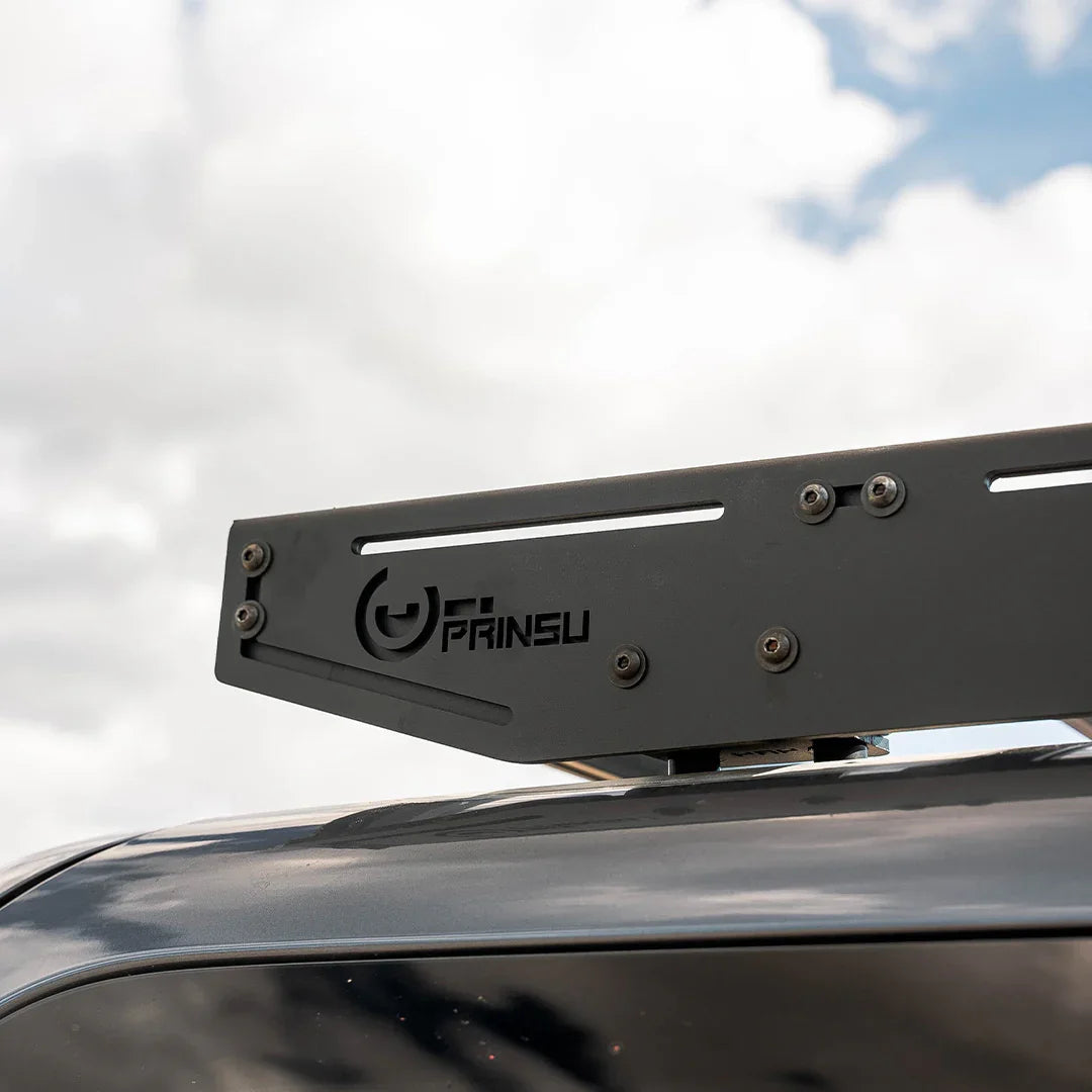 Detail of a Prinsu roof rack mounted on a Toyota 4Runner under a cloudy sky