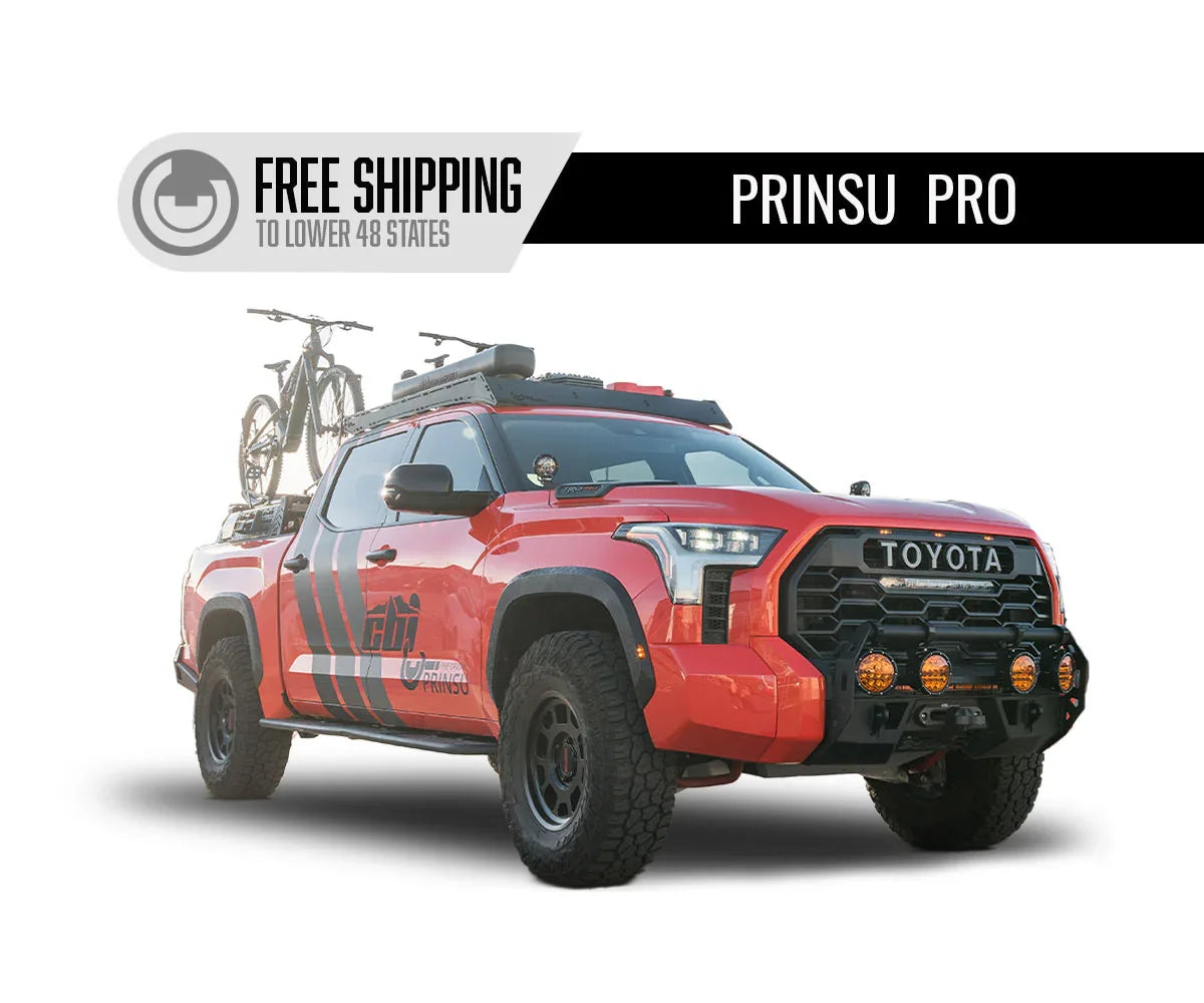 Red Toyota Tundra with Prinsu Pro roof rack, off-road accessories, and bikes mounted on top.