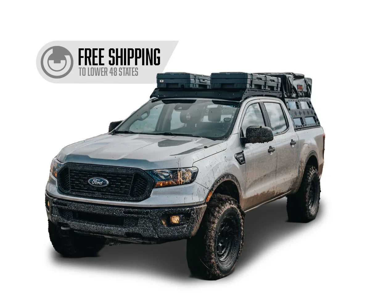 Ford Ranger with off-road roof rack and side storage panels, mud splattered, free shipping badge