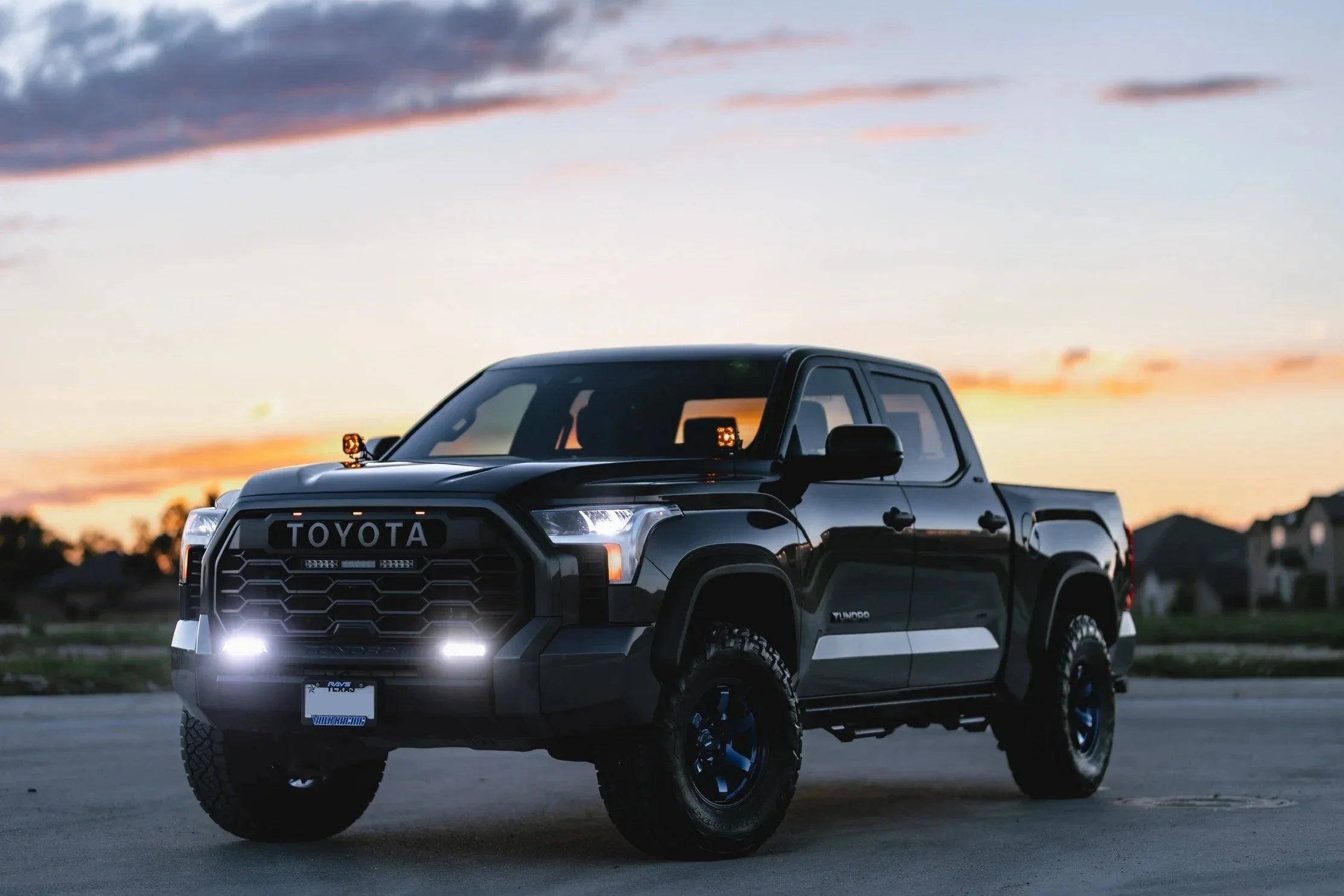 Toyota Tundra off-road truck with aftermarket lights parked at sunset, adventure vehicle