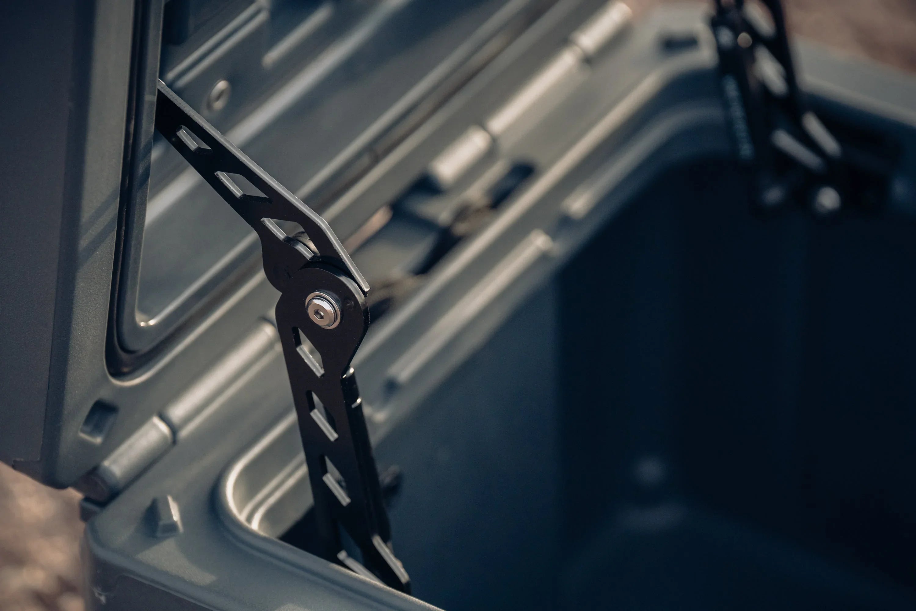 Heavy-duty overlanding storage box with open lid and reinforced metal hinges
