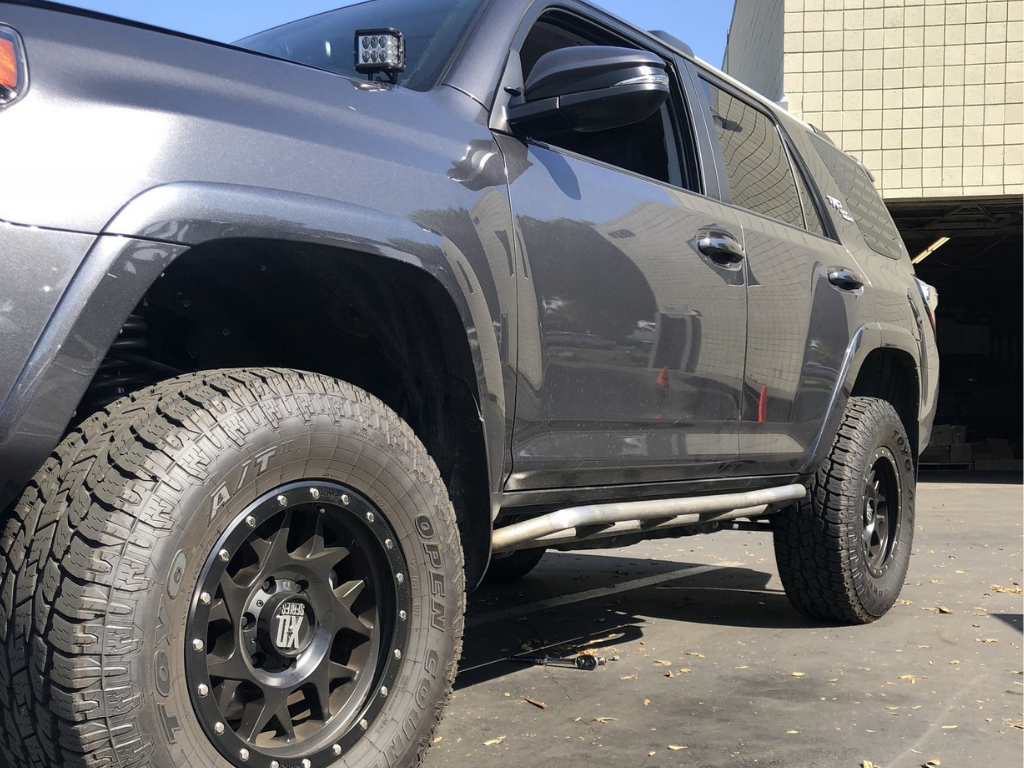Toyota 4Runner with off-road wheels, rock sliders, and LED lights for overlanding