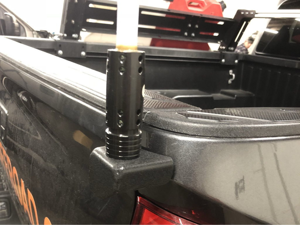 Truck bed rail mount accessory for overlanding gear on black pickup