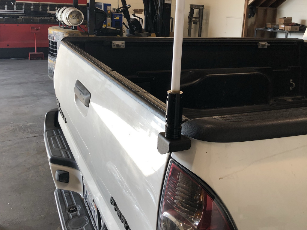 Toyota Tacoma truck bed with whip antenna mount for overlanding gear