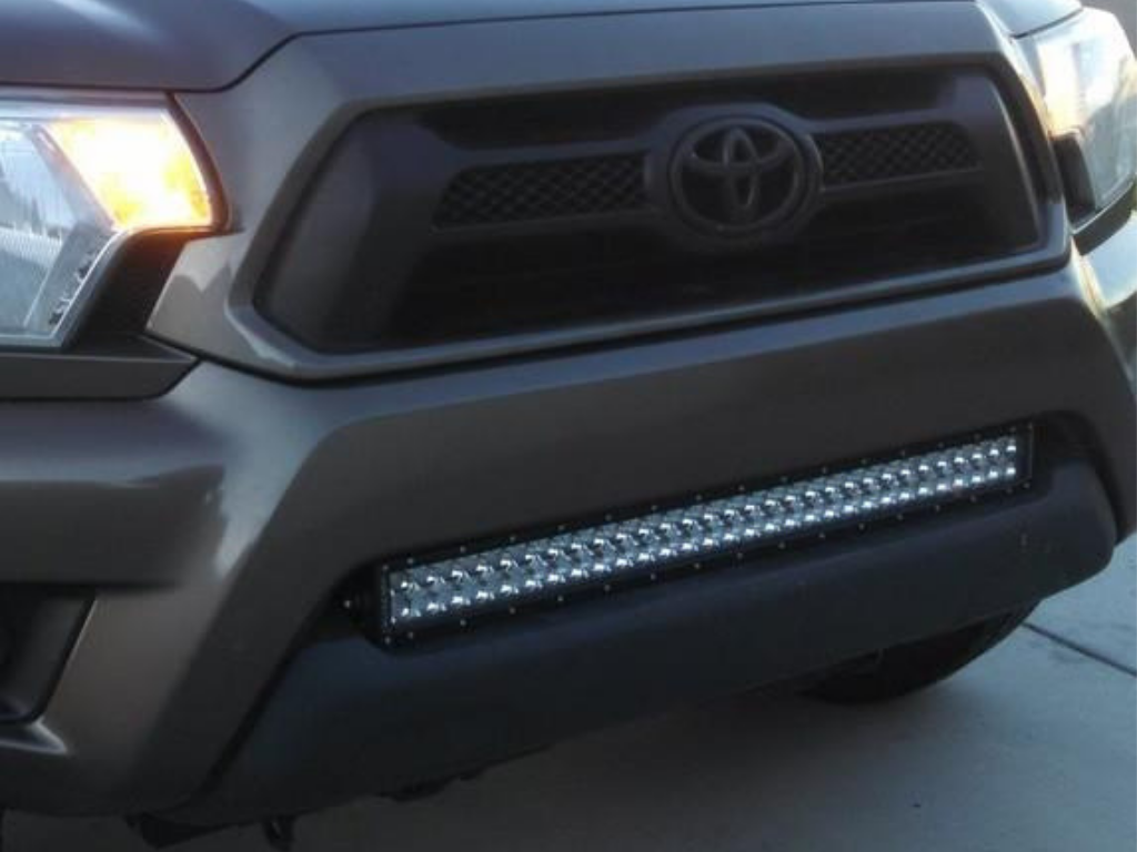 Toyota Tacoma front bumper with installed LED light bar for overlanding and off-road gear