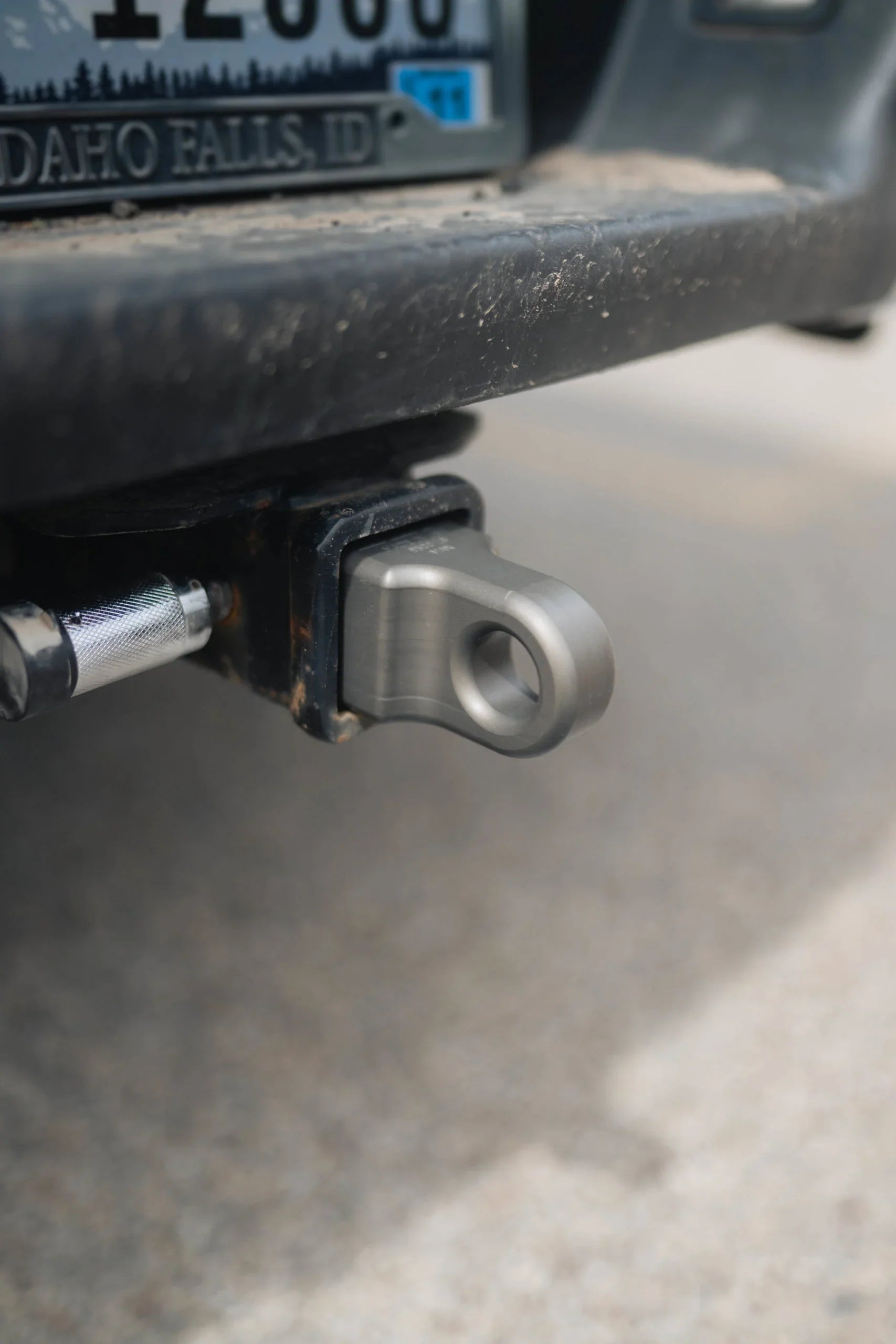 Close-up of a metal receiver hitch point attached to a vehicle bumper for off-road towing