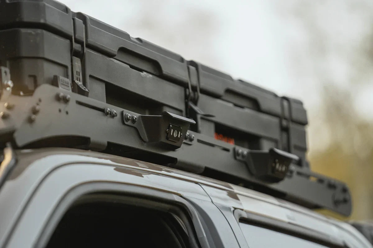 Overland roof rack with mounted black storage case on a vehicle, ideal for expedition camping