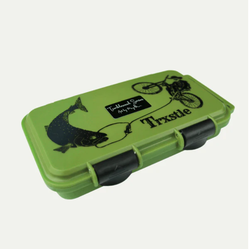 Green waterproof gear box with black fish and bicycle graphics, labeled Trxstle.