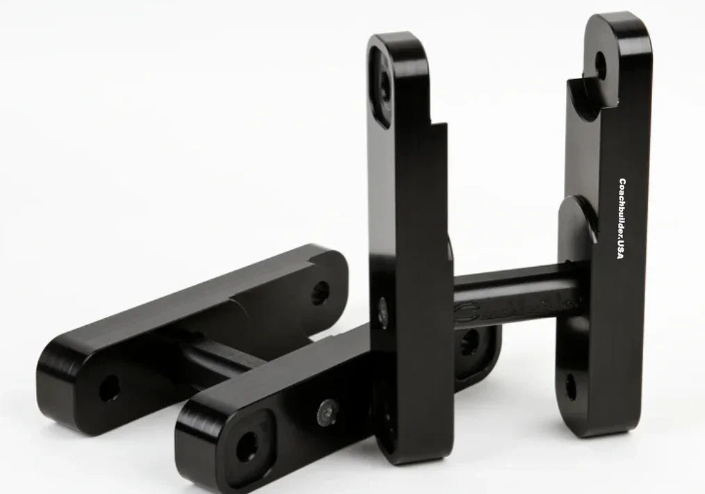Black metal suspension brackets for off-road vehicle, Coachbuilder USA parts
