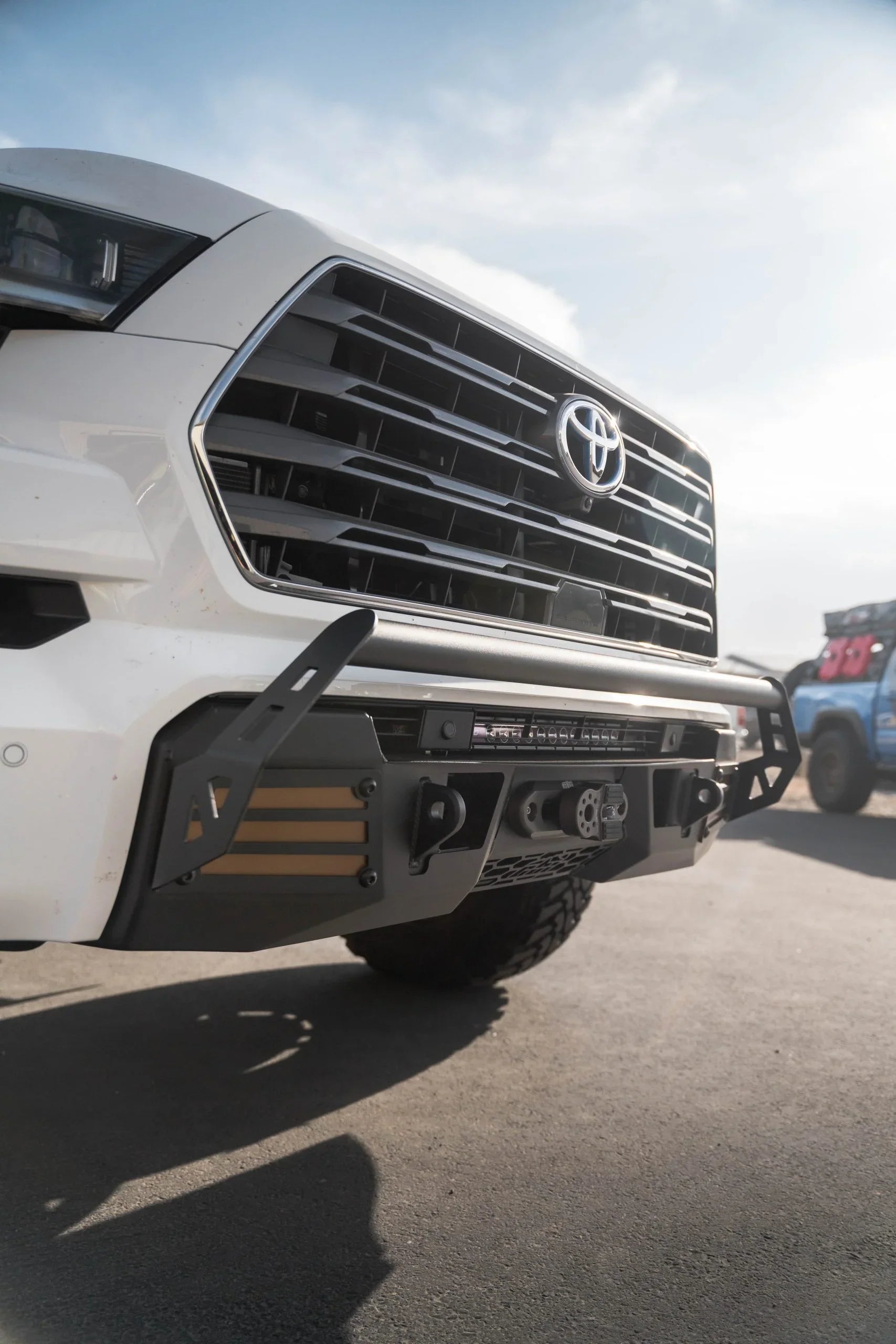 Toyota truck with aftermarket off-road front bumper and accessories outdoors