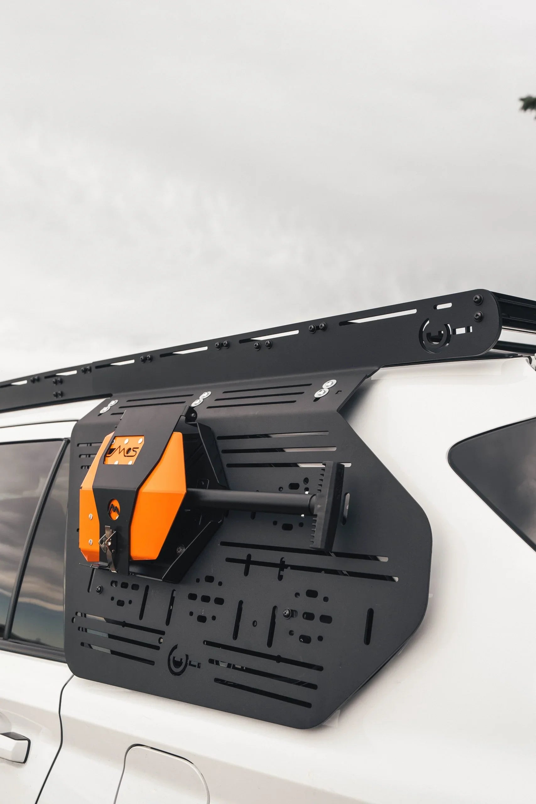 Overland side panel mounting system with gear attached on white SUV