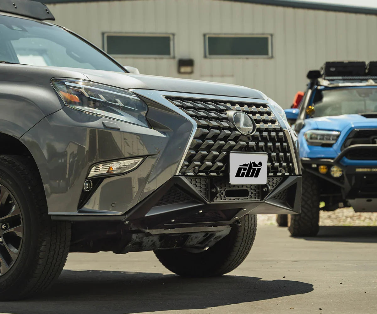 Lexus GX460 with covert front bumper, off-road accessories, Toyota Tacoma in background