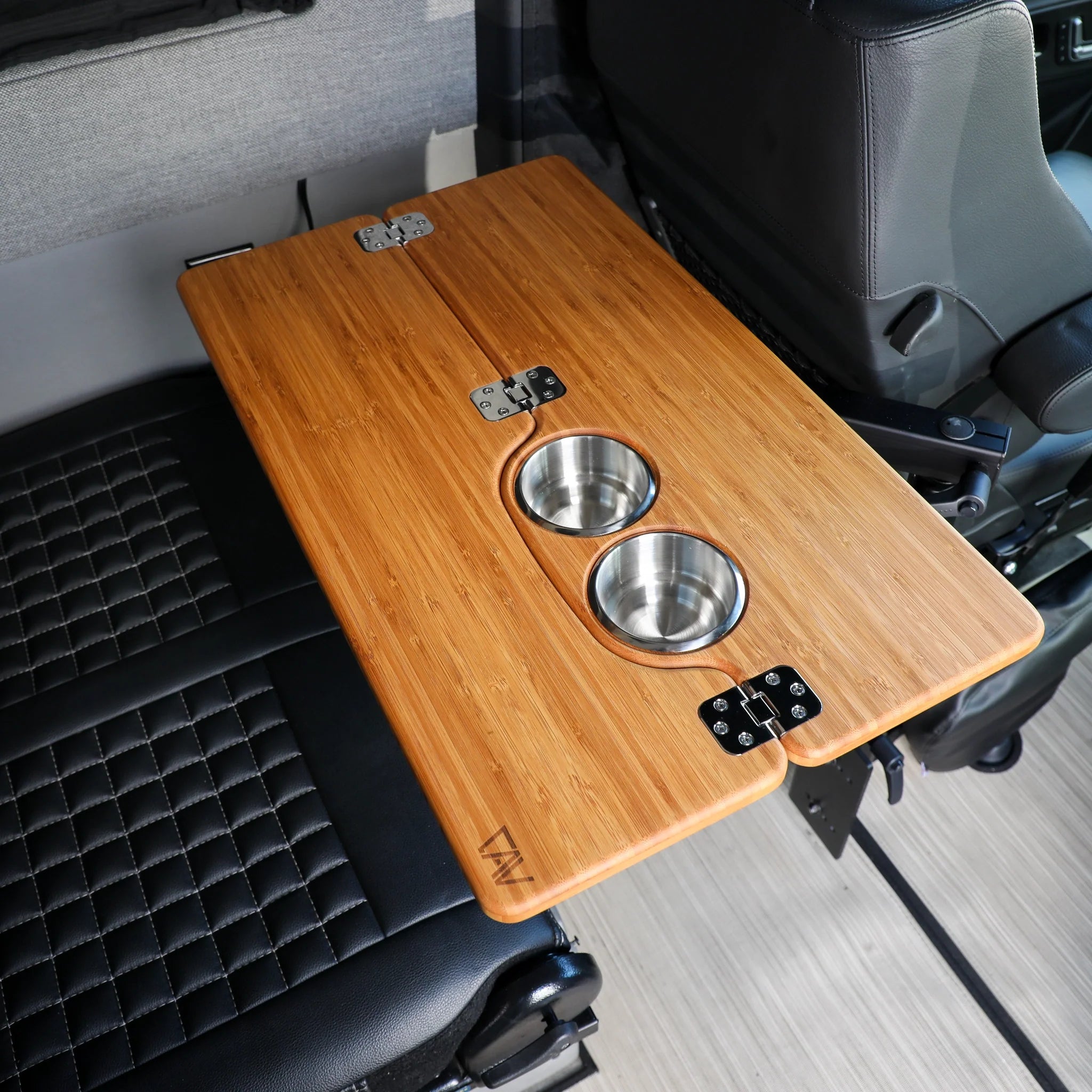 Foldable bamboo vehicle tray table with dual cup holders mounted inside overland camper