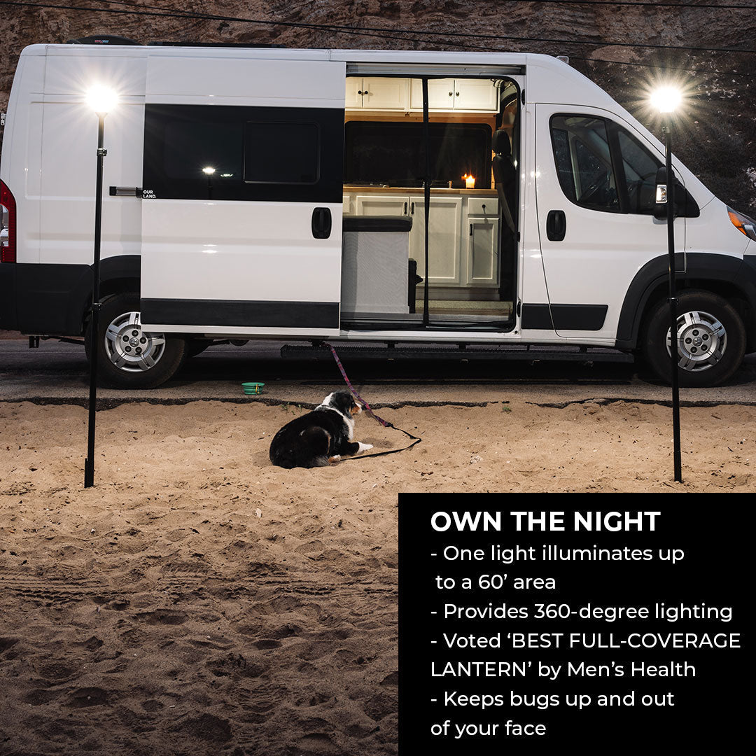Van camping scene at night with outdoor LED lights, dog on sand, overlanding gear setup