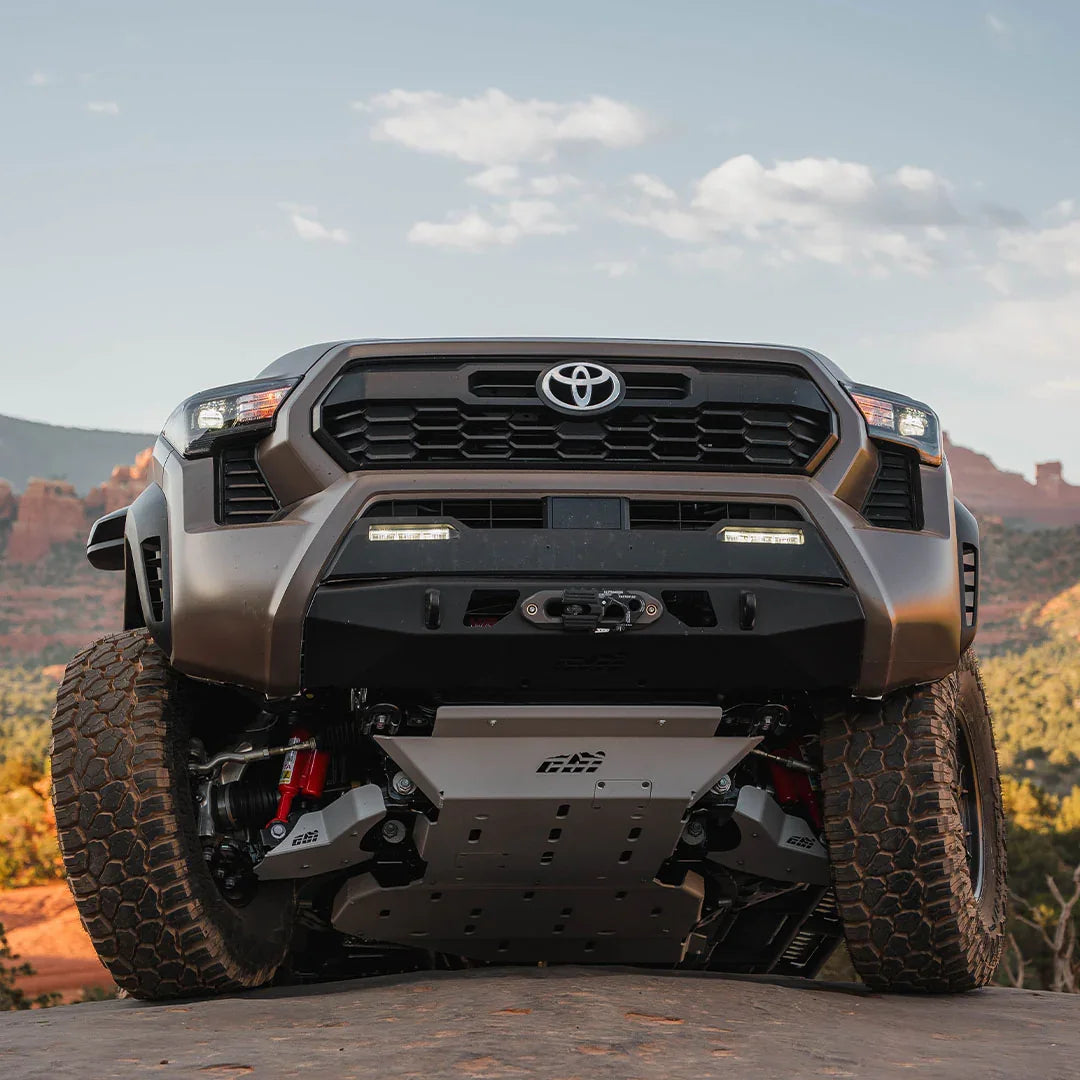 Toyota Tacoma off-road truck with skid plate and large tires on rocky terrain in Sedona