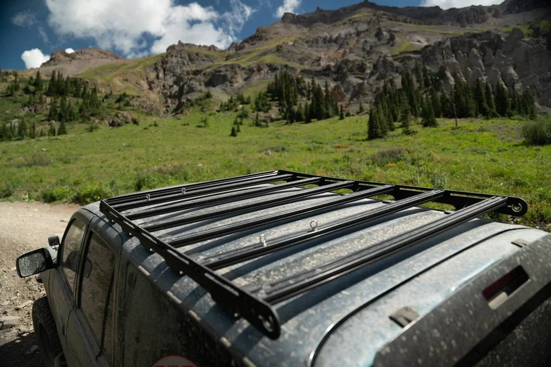 Toyota 4Runner with roof rack parked off-road in a scenic mountain landscape