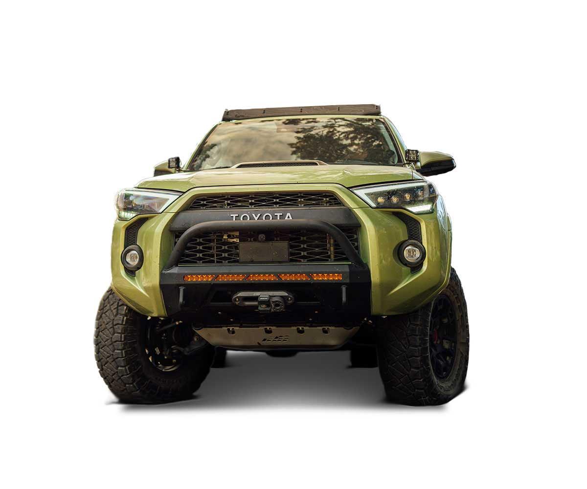 Front view of green Toyota 4Runner with off-road bumper and adventure accessories