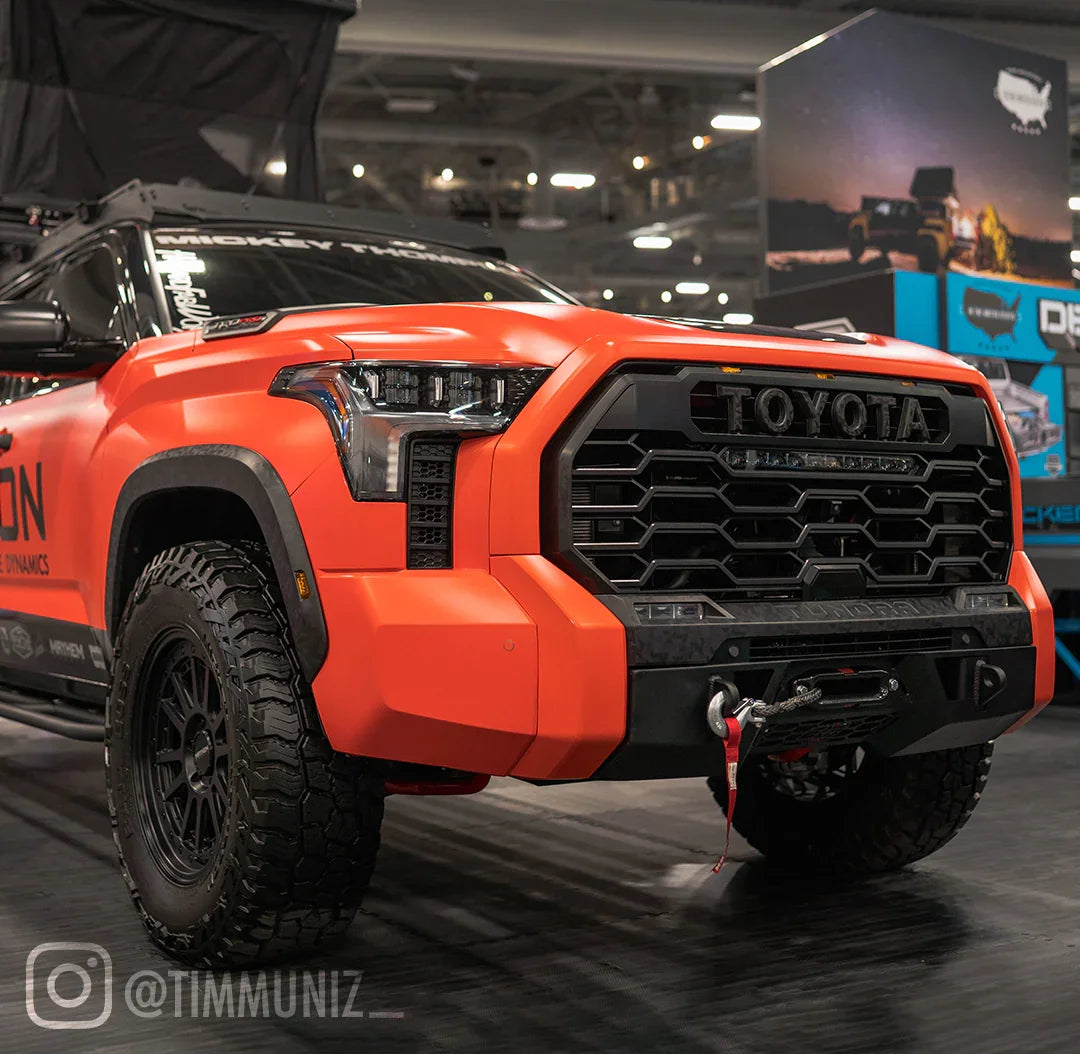 Toyota Tundra with covert front bumper, off-road tires, and winch at auto expo