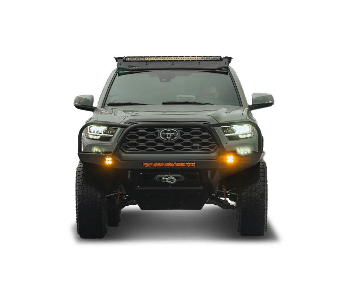 Toyota Tacoma outfitted with off-road bumper, winch, roof rack, and LED adventure lights