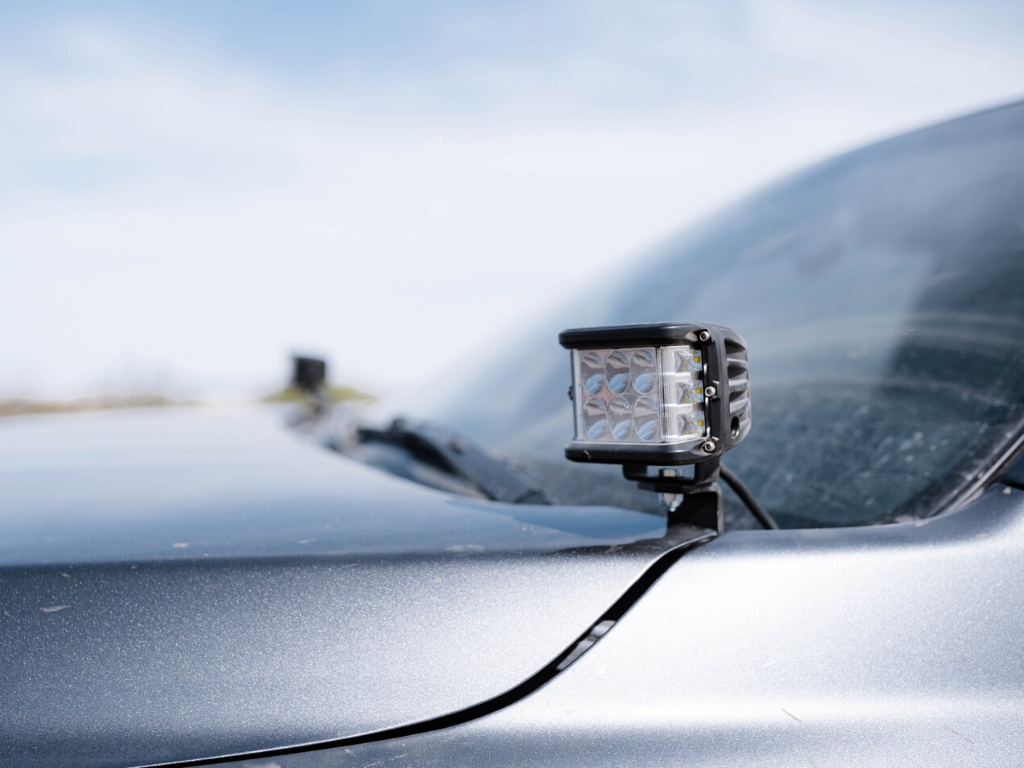 LED ditch light mounted on Toyota Tacoma hood for off-road and overlanding vehicle use