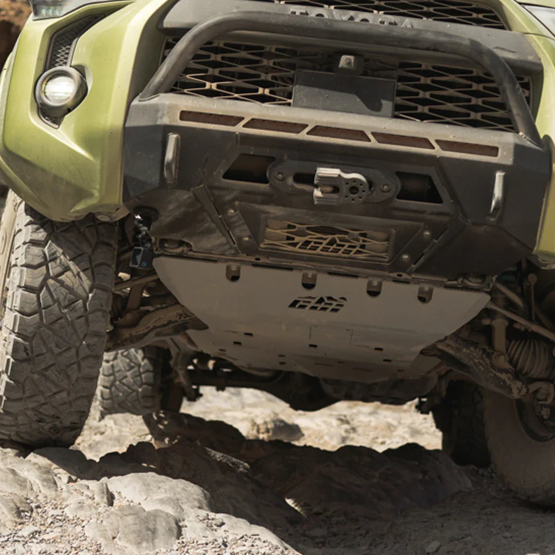 Toyota 4Runner front skid plate on rocky off-road terrain, rugged undercarriage view