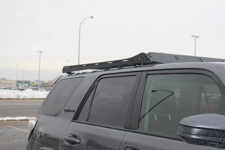 Toyota 4Runner with Prinsu roof rack installed, parked outdoors in winter setting
