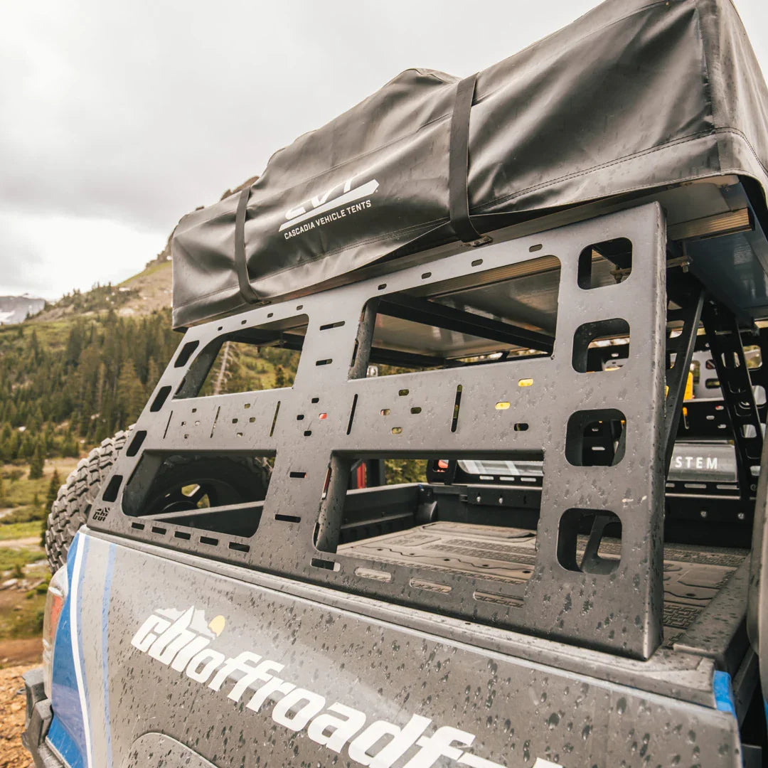 Toyota Tacoma bed rack with mounted roof top tent, outdoor overlanding setup