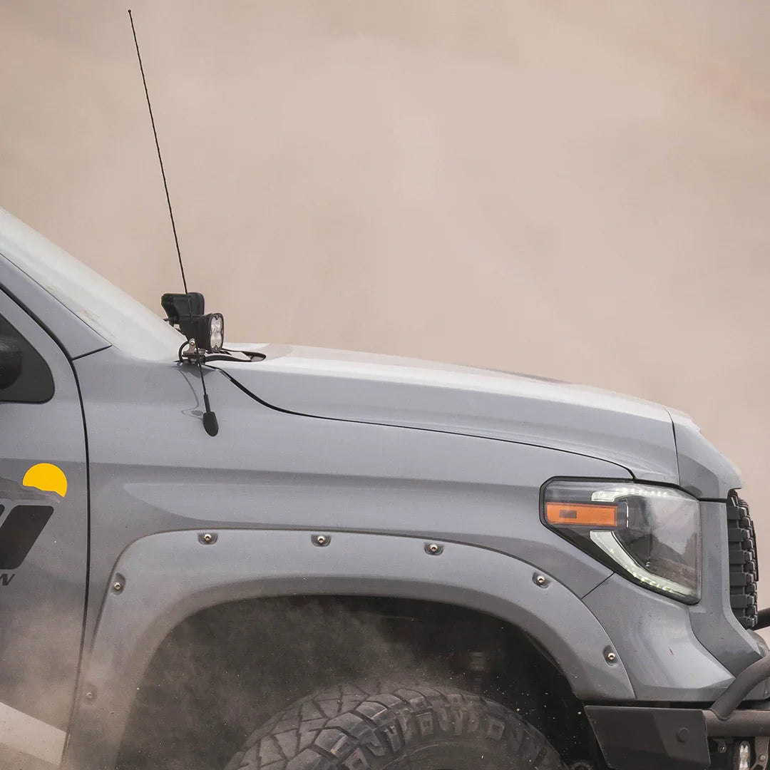 Toyota Tundra with ditch light brackets mounted on hood in off-road desert setting