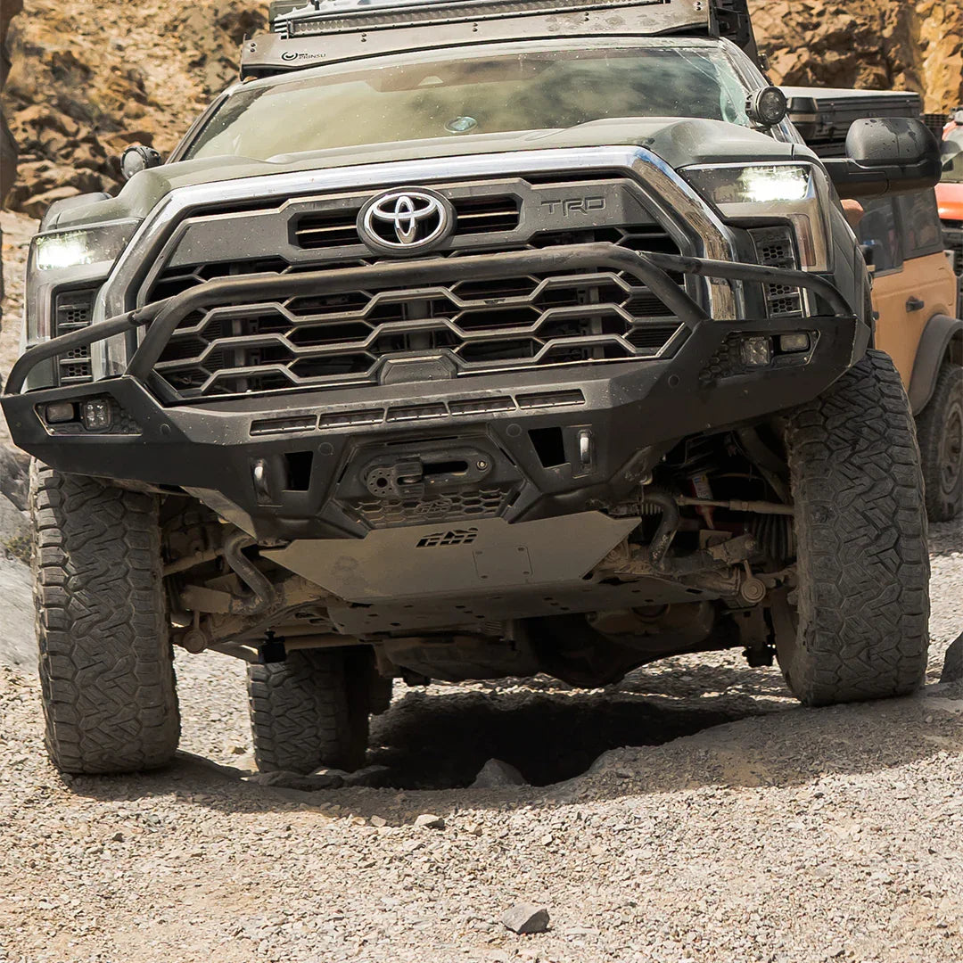 Toyota Tundra with skid plates driving off-road on rocky terrain