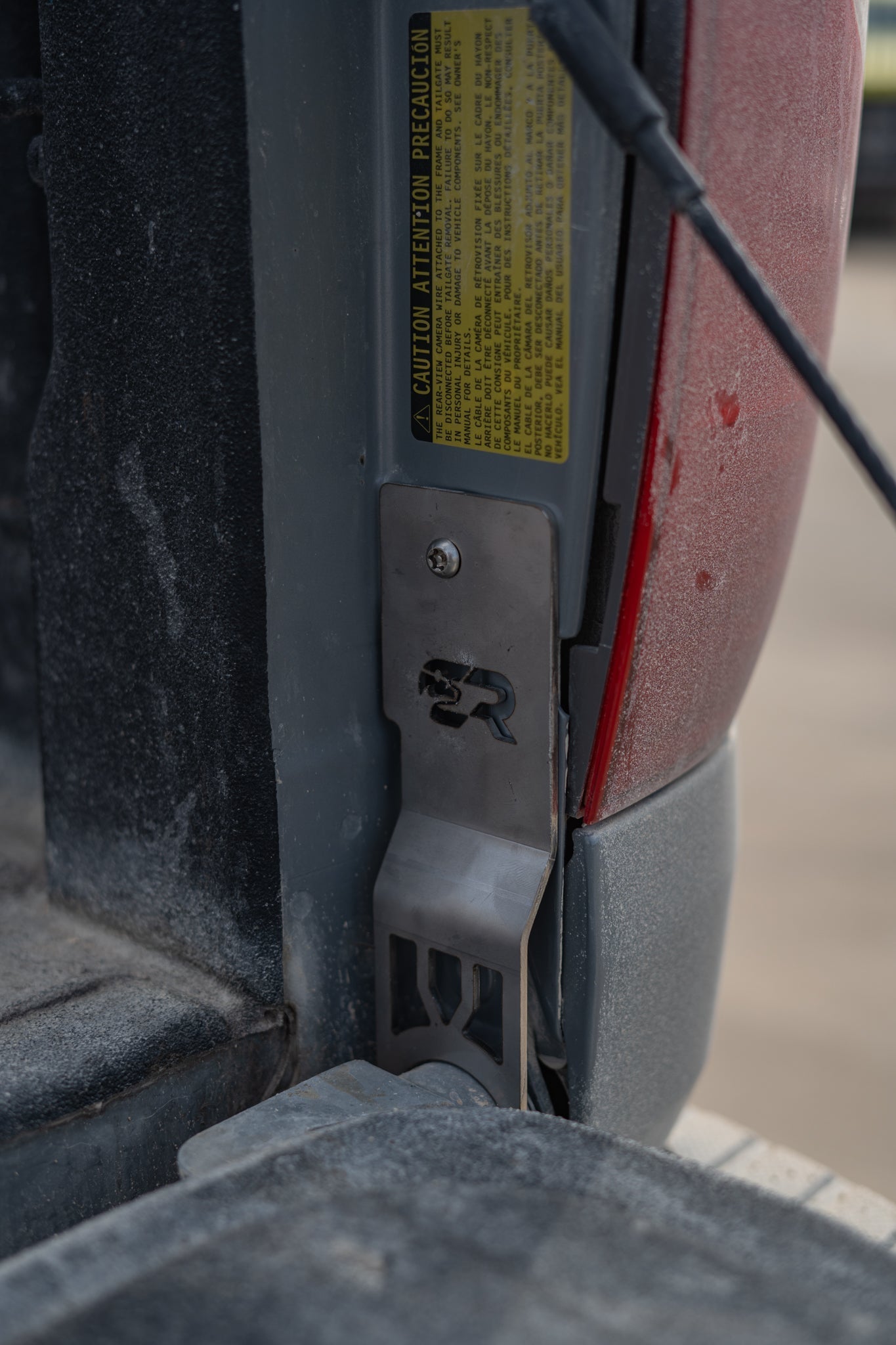 Toyota Tundra tailgate theft protector installed, metal guard securing truck tailgate hinge